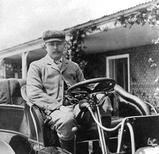 John Scott Montagu sitting in vehicle