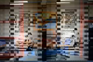 Panoramic view of the reading room with lady researching at desk