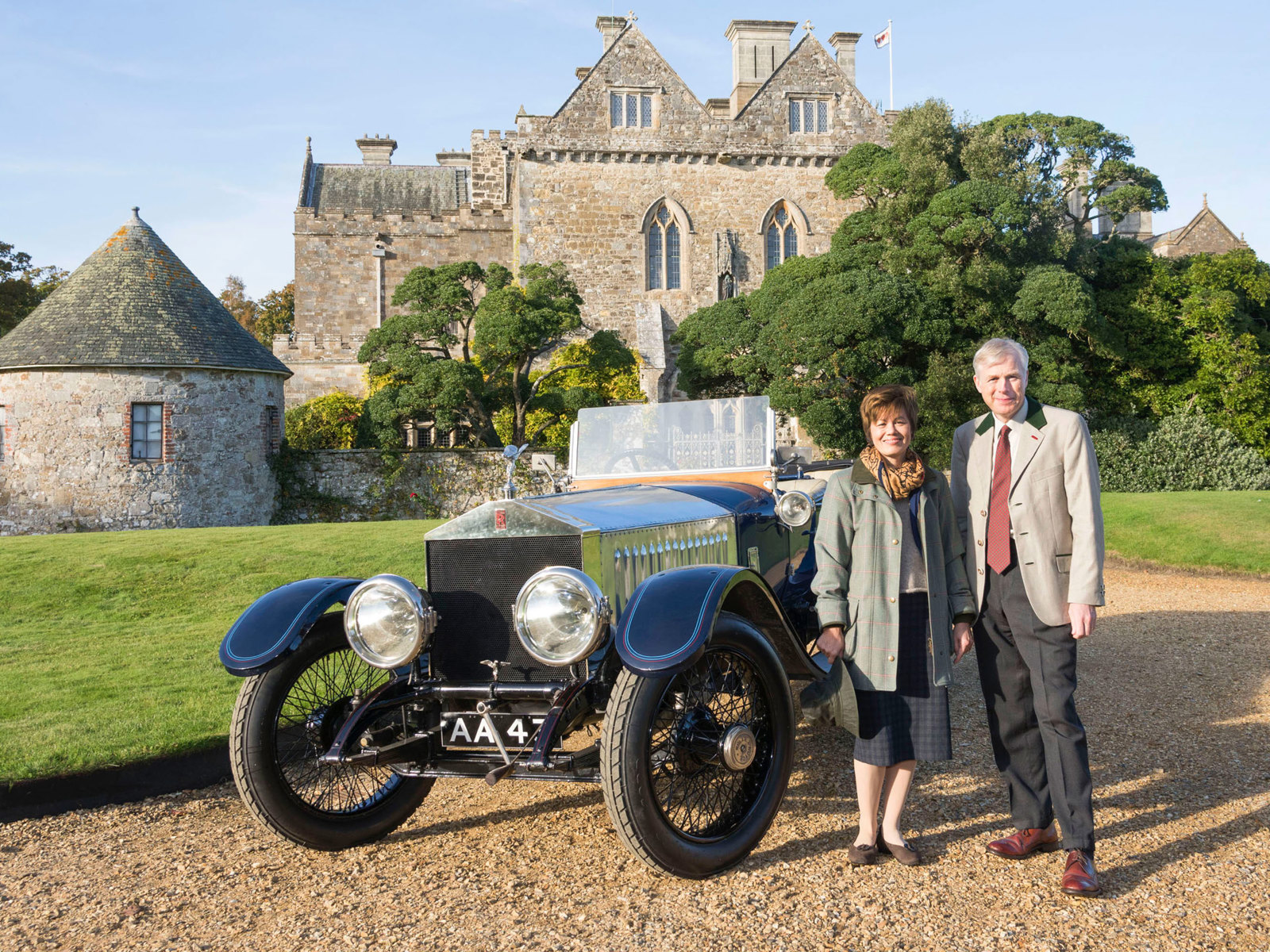 Lord and Lady Montagu with the 1914 Rolls-Royce Alpine Eagle outside Palace House