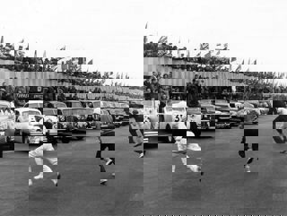 Archive image c1960s of race cars on track with drivers running to their cars