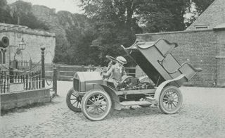 Woman working under the bonnet of a car